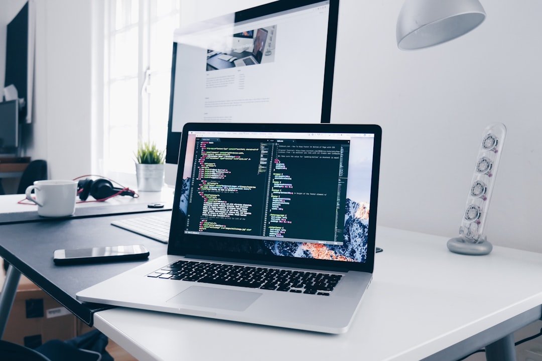 Portátil con código en una mesa de trabajo