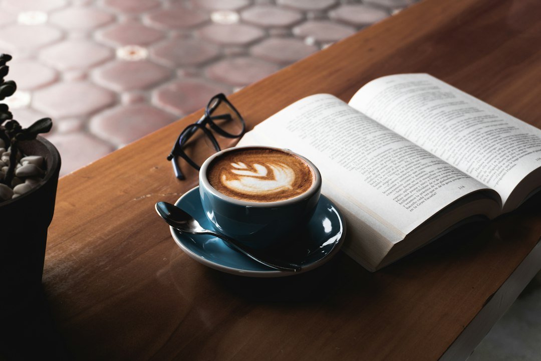 lector electrónico junto a una taza de café